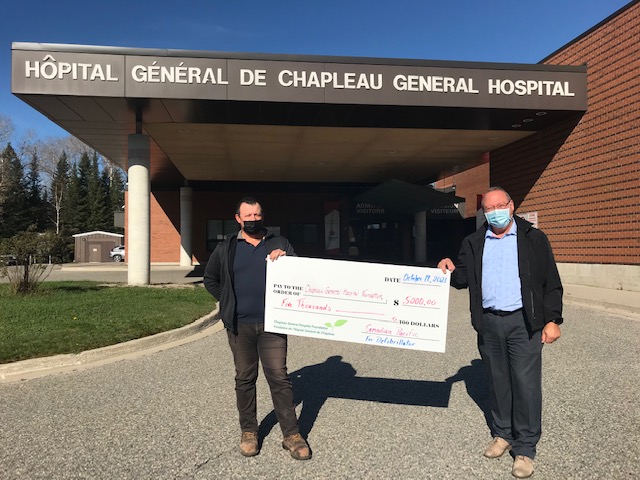 CP employees holding giant donation cheque
