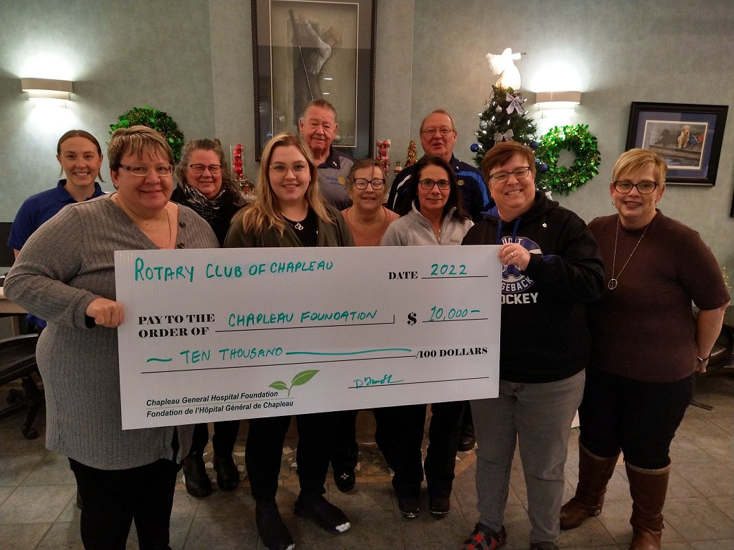 Rotary Club members holding giant donation cheque