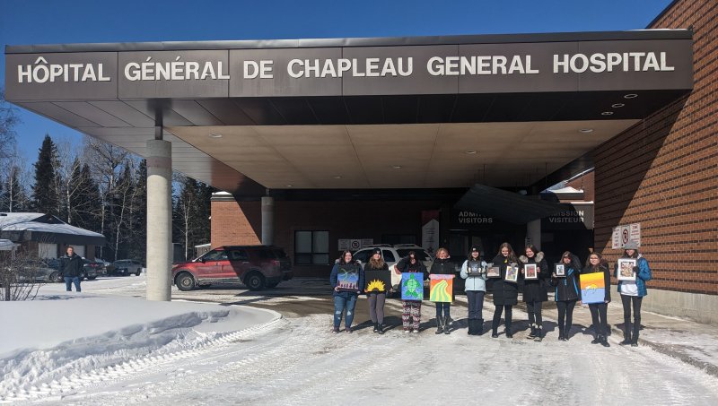 Student Senate from Chapleau Public School holding artwork outside Chapleau Hospital