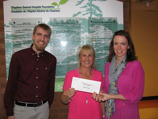 Vacation raffle winner accepts cheque